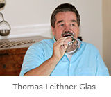 Portrait Thomas Leithner mit Glas farbig
